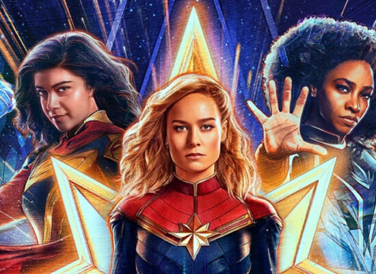 movie poster for The Marvels, featuring Ms. Marvel on the left, Captain Marvel in the center, and Monica Rambeau on the right. There is a galactic vibe to the poster, with all of the characters surrounded by a glowing aura